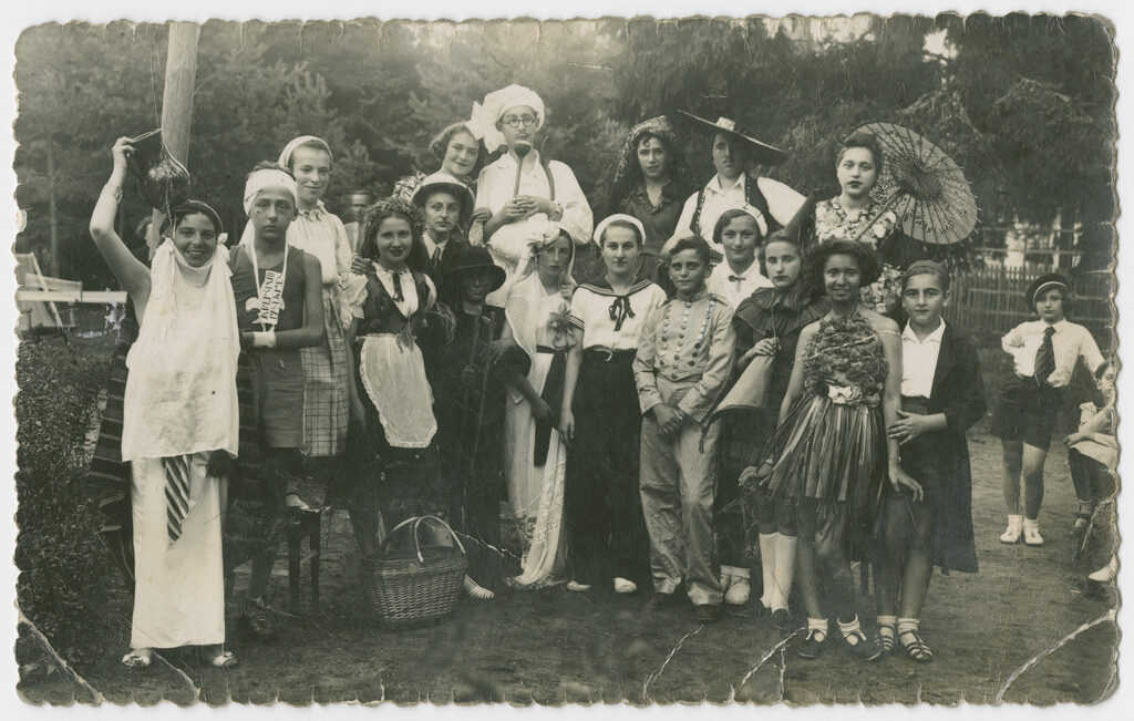 <p>A group of teenagers dressed in [Purim] costumes. Pre-1941, possibly in Kaunas, Lithuania. United States Holocaust Memorial Museum Photo Archives #<a href="https://collections.ushmm.org/search/catalog/pa1181158" target="_blank" rel="noreferrer noopener">81934</a>. Courtesy of Juozas Fedaravicius and Family of Anna Varsavskiene. Copyright of USHMM. </p>