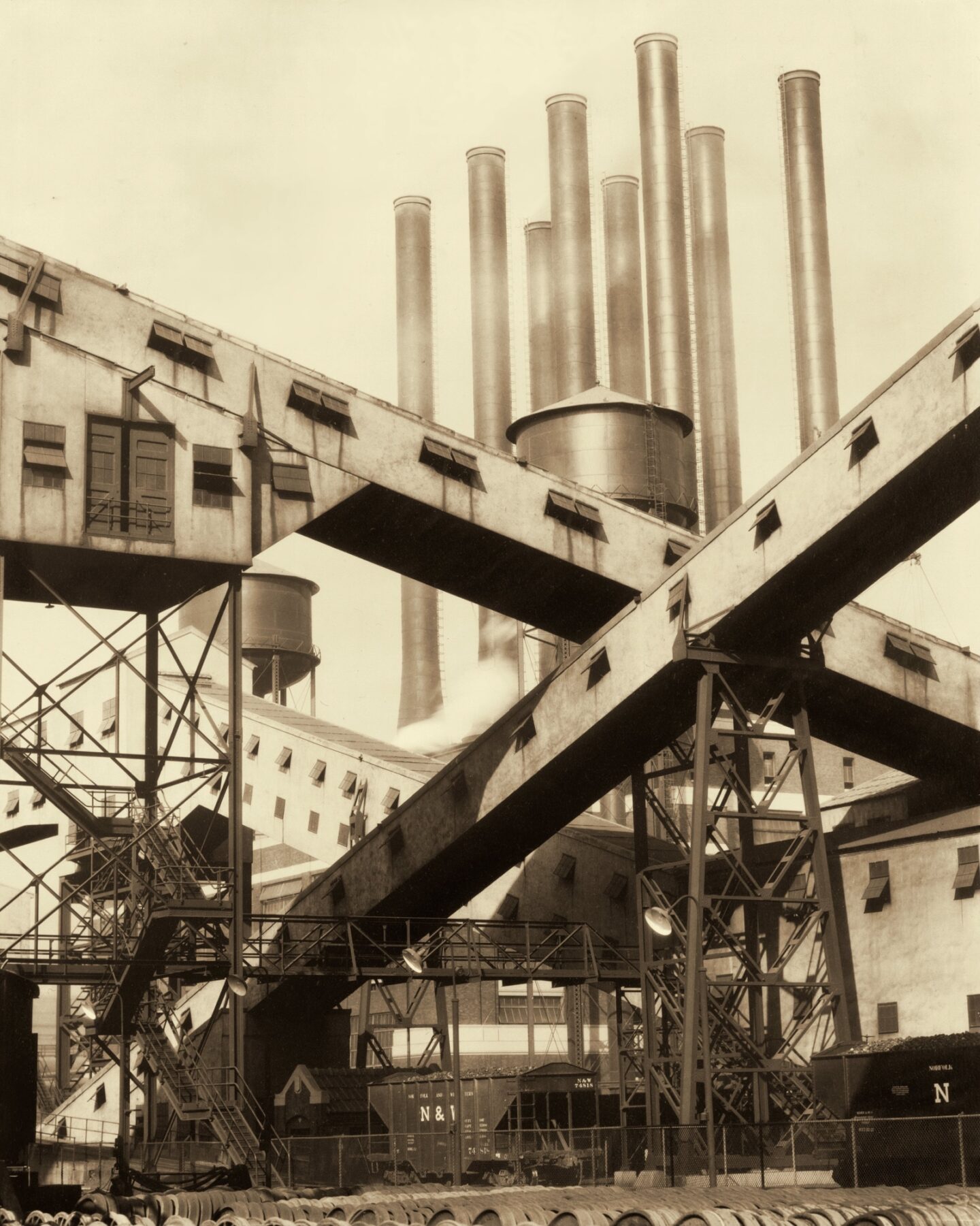 <p><em>Criss-Crossed Conveyors, River Rouge Plant, Ford Motor Company</em>, 1927, by Charles Sheeler. Image courtesy of <a href="https://commons.wikimedia.org/wiki/File:Criss-Crossed_Conveyors,_River_Rouge_Plant,_Ford_Motor_Company.jpg">Wikimedia Commons</a>, <a href="https://www.moma.org/collection/works/49016">MoMA</a> Lane Collection. </p>