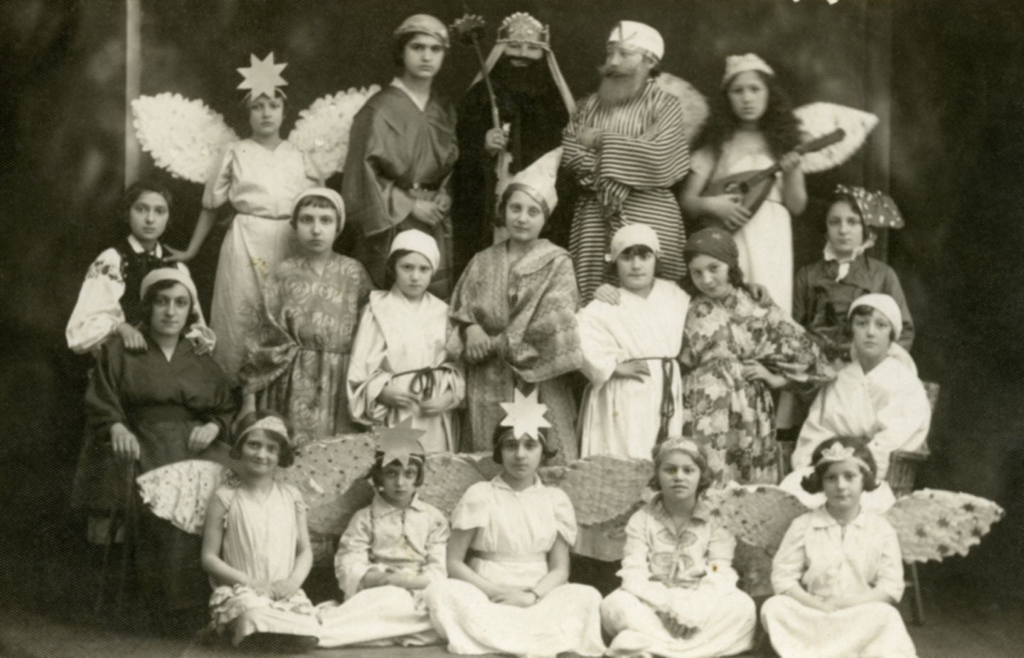 <p>Bais Yaakov
students in Buczacz perform in a play called “Joseph and His Brothers.” Esther
Wagner can be seen in the second row, fifth from the right. Esther Rivka Wagner
(born Esther Willig) is the daughter of Rabbi Shraga Feivel Willig (b. 1870)
and Sarah Chaya Blei (b. ca. 1890). Bais Yaakov students in Buczacz perform in
a play called “Joseph and His Brothers.” Esther Wagner can be seen in the
second row, fifth from the right. Esther Rivka Wagner (born Esther Willig) is
the daughter of Rabbi Shraga Feivel Willig (b. 1870), the rabbi and mohel of
the city, and Sarah Chaya Blei (b. ca. 1890). Courtesy of the United States
Holocaust Memorial Museum.</p>