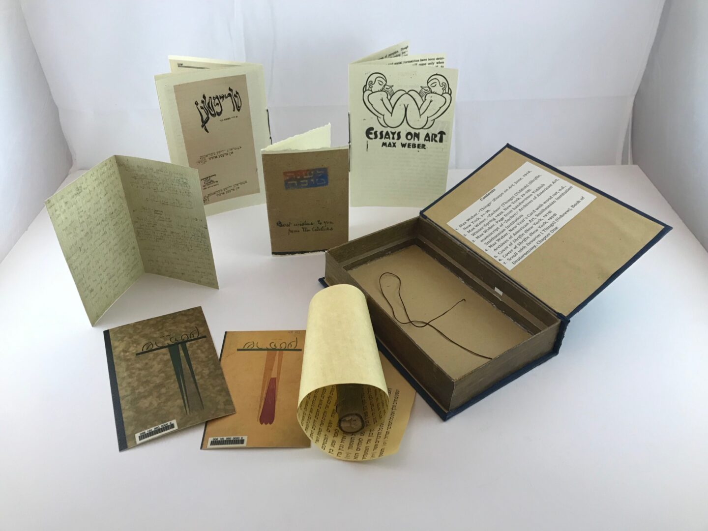 <p>artist’s book “Things/<em>Zachen</em>/<em>Devarim</em><em>,</em>” open and displaying objects to handle</p>