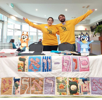 <p>Reyzl Zylberman and Daniel Goldberg, Yiddish Sof Vokh Committee members, celebrating Yiddish with Bingo and Bluey</p>