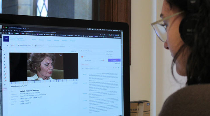 <p>Staff working with the digital collection at the archive. Photo Credit: Stephen Naron</p>