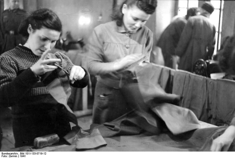 <p>Jewish workers in a clothing workshop in Lodz, 1941. Credit: <a href="https://commons.wikimedia.org/wiki/File:Bundesarchiv_Bild_101I-133-0719-12,_Polen,_Lodz,_Juden_in_einer_Schneiderei.jpg" target="_blank" rel="noreferrer noopener">Bundesarchiv</a> Collection.</p>