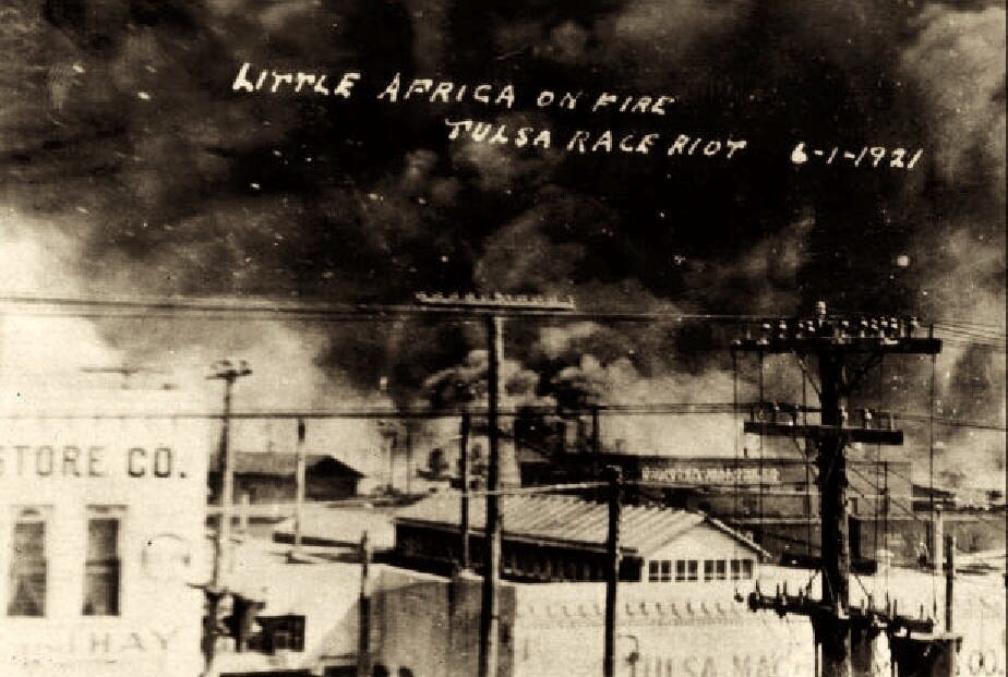 <p> Postcard in the collection of McFarlin Library, University of Tulsa, via Wikimedia Commons.</p>
<p><em>Little Africa on fire. Tulsa Race Riot, June 1st, 1921</em> This photo was taken from on top of the Santa Fe Freight office at 1st St. and Elgin Ave., showing the fires on Archer towards Greenwood. The Goodner-Malone company (1 N. Frankfurt) building is in the center of the photo.</p>